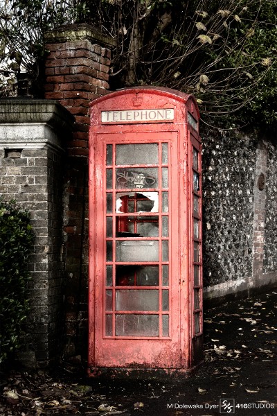 vandalized red phone booth 