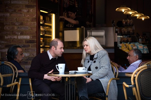 street photography couple in the cafe gossip over coffee lifestyle shot